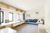 Another former teacher’s lounge was converted into a kid's bedroom. For consistency, simple plywood, lightly coated with lacquer, was used for custom furniture and shelving. Photo 6 of The Schoolhouse modern home