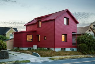 Waechter Architecture reimagined a traditional gabled home in southeast Portland without significantly altering the original building. A simple coat of red paint abstracts the century-old structure, creating a residential work of art.