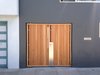 Modern home with Doors, Wood, Exterior, and Swing Door Type. The focal point of the home’s modernized exterior is a custom, wood-and-steel entry gate designed by atelier KS and built by DeFauw Design + Fabrication, a local fabricator who also made custom closing hardware for the piece. Franz and Paré-Mayer paired angled cypress slats with an industrial metal frame to create the entryway. A few paces behind the gate, a large glass door provides direct access to the home, fulfilling the owners’ wish for an entry vestibule that would be separate from the street. The angled wood slats offer privacy from the exterior, while selectively allowing light to penetrate through. Photo 10 of KS Mission