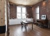 Modern home with Dining Room, Chair, Ceiling Lighting, Table, and Dark Hardwood Floor. The entire flat features in-floor heating underneath pre-oiled engineered oak planks manufactured locally by Bois Ditton. Like most of the apartment's built-ins, the heat source was designed to be unobtrusive but effective. Photo 2 of Brick House