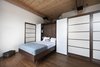 Modern home with Bedroom, Bed, Dark Hardwood Floor, Recessed Lighting, Shelves, Storage, and Accent Lighting. In an 850-square-foot loft in Montreal, Quebec–based firm Gepetto built understated, custom cabinetry to suit an aging couple's needs. Here, the Murphy bed that folds into a larger walnut storage unit. The wall, which also conceals a washer and dryer, does double duty as a partition between the bedroom and the loft’s entrance. Modern Murphy beds like this one often incorporate sleek lines constructed in dark-toned woods. Photo 6 of Brick House
