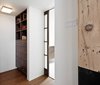 The architects had to master the art of hiding storage throughout the apartment, including with this custom walnut organizer. As the homeowners near retirement age, the architects explain that the flat is a “highly functional and sophisticated space that will serve them well as they begin another phase in their life together.” Photo 7 of Brick House modern home