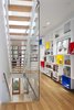 “The interior was designed as a backdrop to the art and life of its inhabitants,” Clarkson noted. “A custom-built wall of display cubes adds an accent of primary color in the second floor hallway.” Solid white oak flooring continues onto the second level from the stairs, and Middlebrook Woodworking Ltd. lacquered that same material for the display cubes. Photo 6 of King West modern home