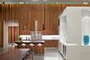The house features 16-foot-high ceilings and is heated and cooled primarily from geothermal ground loops, with radiant lines inside the concrete floors. A central "cube" designed and fabricated by the architects offers pantry storage and delineates the kitchen, living, and bar areas. The glossy sheen comes courtesy of white automotive paint. Photo 6 of Omaha Art-Inspired House modern home