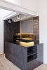 Modern home with Kitchen, Wood Cabinet, and Light Hardwood Floor. "The kitchen refers to London’s feeling the most," says Stepanova. Pendant lamps from Normann Copenhagen illuminate the kitchen, all of which was fabricated by the woodworking studio Dyzyk according to Stepanova's designs. Photo of A Sleek Kitchen and Double Bathroom Renovation in Prague