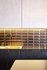 Modern home with Kitchen and Ceramic Tile Backsplashe. Golden brown subway tiles from Diffusion Ceramique face a black countertop from Fundermax. Photo of A Sleek Kitchen and Double Bathroom Renovation in Prague