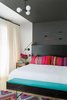 The bed in the master bedroom is a custom JHID design in ebony-stained fir. Lighting is kept subtle, in the form of an overhead fixture by Schoolhouse Electric and wall sconces by Workstead. The arrows are by Fredericks and Mae. Photo 7 of Color Splash modern home