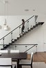 Modern home with Staircase, Wood Tread, Metal Railing, and Glass Railing. This staircase connects the common area to the guest suites above and the wine cellar below. The interplay of glass and metal on the handrails is a one of the architects’ favorite details. Photo 5 of Noe Residence