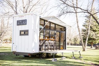 Unpacking the deck and awning reveals a glass wall that opens the trailer to its environment, wherever that may be. The ATLAS can be hitched to a truck to travel easily from campsite to campsite.