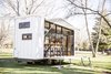 Modern home with Exterior, Camper Building Type, and Flat RoofLine. Unpacking the deck and awning reveals a glass wall that opens the trailer to its environment, wherever that may be. The ATLAS can be hitched to a truck to travel easily from campsite to campsite. Photo of A Tiny Trailer Home Harvests Solar Power and Rainwater to Save Energy