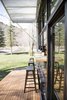 Generous windows and a split indoor-outdoor benchtop help bring the outside in. Photo of A Tiny Trailer Home Harvests Solar Power and Rainwater to Save Energy modern home
