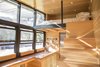 Modern home with Kitchen, Wood Counter, and Wood Cabinet. With a built-in sofa and sleeping loft, ATLAS can accommodate three adult travelers. Photo of A Tiny Trailer Home Harvests Solar Power and Rainwater to Save Energy