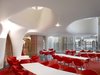 The restaurant has a glass facade that stretches between the building's pillars. Photo of Hospitality Favorites modern home