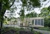 “Our central challenge was to add a home to the forest without undermining nature,” architect Paul Bernier says. “We allowed the house’s function and relationship with its site to shape the design.” Photo of House of Lake Grenier modern home