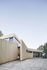 The main entrance to the house is partially concealed, allowing the structure to blend into its environment. While soil currently surrounds the structure, natural vegetation will gradually regenerate. Photo 2 of House of Lake Grenier modern home