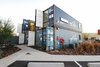 Modern home with Exterior, Apartment Building Type, Shipping Container Building Type, Metal Siding Material, Metal Roof Material, and Flat RoofLine. The apartments face a landscaped common courtyard. The site is an irregular trapezoid, a fact the zig-zagging sidewalks reflect well. Photo of 20 Ideas On What You Can Do With Old Shipping Containers