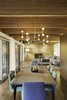 “The new floor plan is considerably more open than the original plan, and the interior and exterior details have been simplified and made consistent,” Schultz said. A Lambert & Fils light fixture illuminates a dining set by Ligne Roset. Photo 4 of City Skyline modern home