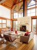 The design pairs durable steel construction on the outside with warmer timber frames on the interior. At the center of the expansive glass wall stands a two-sided fireplace that can heat the deck outside and living room within. Seen here are a Restoration Hardware Brickmaker’s coffee table and sofas from Lee Industries. Photo of House of the Week: An Eco-Friendly Family Retreat Built with Reclaimed Materials modern home