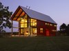 Don’t let its traditional silhouette fool you: this home features a grid-tied solar photovoltaic array just south of the property, which supplies the family’s annual average powers usage. Large steel beams and columns flank the patio, framing views of the landscape. Photo of House of the Week: An Eco-Friendly Family Retreat Built with Reclaimed Materials modern home