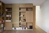 Modern home with Storage Room and Shelves Storage Type. More custom millwork features asymmetrical shelving and closed storage spaces with sliding panels on HAFELE sliding tracks. A 10-inch matching pocket door provides privacy when desired without interrupting the space. Photo 4 of White Oak
