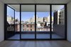 The fifth story was added late in the design process because “our clients wanted to have their own private space,” Ruggieri says. The stunning north view across Manhattan from the penthouse is one of the home’s best features, outlined in black steel windows by Optimum. Photo 10 of White Oak modern home