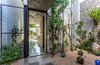 Modern home with Outdoor, Small Patio, Porch, Deck, and Stone Patio, Porch, Deck. Several courtyards help bring greenery in. On the west side of the home, plants absorb sunlight and create another passive cooling feature. Crushed limestone pebbles and an exposed stone wall complete the lush space. Photo of A Sustainable Mexican Retreat Made of Raw, Readily Available Materials