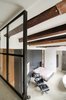 The original beams, as seen from the loft, offer a warm and textural contrast to the sleek and modern finishes introduced during the renovation. “There's a lot of nice patina to the very old beams; we definitely wanted to show that,” says van Hulzen. Photo 2 of Bloemgracht modern home