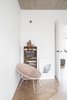 No space is wasted in the apartment—even behind-the-door corners. A statement bowl chair from the 60s, bought at an English flea market, makes for a stylish reading nook. Photo 5 of Soviet Intelligentsia modern home