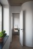 To make the most out of a small footprint, Vorontsov experimented with some creative partitions. He explains how “the partitions we built were straight, and then we rounded the corners slightly in the studio" to create a little extra room. "We left the doors without architraves, and punctuated the detail with black doorknobs.” Photo 6 of Soviet Intelligentsia modern home