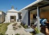 The front portion of the structure, which contains the existing bungalow, houses the bedroom, kitchen, and dining area. Photo 3 of Cut Cut Paw Paw modern home