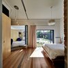 Three plywood veneer sliding doors separate the bedroom from the hallway. Photo 7 of Cut Cut Paw Paw modern home