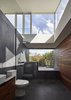 Modern home with Bath Room, Two Piece Toilet, Drop In Tub, Open Shower, Recessed Lighting, and Vessel Sink. An Envy II Wall-Faced Suite toilet by Parisi sits in the home’s sole bathroom and Caroma’s Starlett 1850 Island Bath was installed next to the window. Photo 7 of Breeze