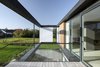 Modern home with Outdoor, Side Yard, Metal Fences, Wall, Wood Patio, Porch, Deck, Small Patio, Porch, Deck, Shrubs, Decking Patio, Porch, Deck, Grass, and Hanging Lighting. Located in Aarhus, Denmark, Villa R is a minimalist, serene structure clad in zinc panels. "The objective was to create a house that brings the forest inside through large glass panels—and create an ever-changing seasonal backdrop for the interior living spaces," stated the architecture firm, C.F. Møller, of the 3,200-square-foot abode. Photo 2 of Villa R