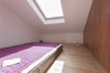 The ladder from the kitchen leads to this "sleeping box," a tucked-away room perfect for visiting relatives, or as Heierle discovered during a trip to work on the project, visiting architects. When light streams through the skylight and down into the hallway below, it adds an "almost mystic element," says Heierle. Photo of Minimal Romanian Attic Renovation Complete with an Epic Bathtub modern home