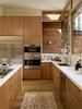 Modern home with Kitchen, Light Hardwood Floor, Marble Counter, Refrigerator, Wood Cabinet, Cooktops, and Wall Oven. In addition to Wolf and Sub-Zero appliances, the kitchen features an on-demand hot water recirculation pump that reduces wasteful water heating. Schwinn cabinet pulls adorn the custom cabinetry and the K7 faucet is from Grohe. Photo of A Couple Puts Their California Home on Track for LEED Certification