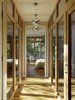 Modern home with Hallway and Light Hardwood Floor. A bridge connects the second-floor office and guest bedroom with the backyard-facing master bedroom. To prevent excessive solar heat gain in this especial space, Butler Armsden used high performance Unilux low-e windows. Two Eurofase pendant lights from Chromos illuminate the hallway at night. Photo of A Couple Puts Their California Home on Track for LEED Certification