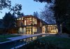The three pavilions were placed along the lot's two natural north-south and east-west axes, delineated here by the concrete pavers. These axes helped both the homeowners and architects layout the pavilions, lap pool, and landscape elements. At night, the house shows off its nearly 100 percent LED lighting scheme. Photo of A Couple Puts Their California Home on Track for LEED Certification modern home