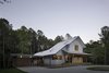 Modern home with Exterior and House Building Type. “It was important to site the house in such a way that it had views to both the field and the forest, but it also wasn’t visible from the main road,” says Lewis. VELUX skylights bring extra light into the home. Photo 2 of The Farmhouse