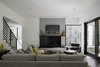 Modern home with Living Room, Chair, Standard Layout Fireplace, and Sofa. “We had to take into consideration that this young family was going to be living on a viable farm,” says interior designer Kris Ozburn of Second Mile Design. “So, selecting furniture that was practical but had good design was a priority.” Ozburn chose pieces like the sectional sofa from Precedent that felt timeless and modern. Photo 5 of The Farmhouse