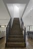 Modern home with Staircase. Stained oak flooring was used throughout the home’s ground level, and continues up the main stairwell. Painted steel was used for the guardrails. Photo 6 of The Farmhouse