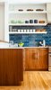 Modern home with Kitchen and Ceramic Tile Backsplashe. The residents have a particularly strong sense of color and love to cook with their son, so no-fuss finishes likes these blue tiles from Heath Ceramics were an ideal choice. The tiles combine with colorful tableware and custom walnut cabinetry to make a vibrant inteiror. Photo of A Fresh Kitchen Update for the Family That Cooks Together