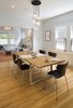 Modern home with Dining Room, Table, Chair, and Pendant Lighting. The dining room is a more formal setting where classic Series 7 Arne Jacobsen chairs mingle with a contemporary Essay table by Cecilie Manz for Fritz Hansen. The lighting overhead is the same John Pomp Studios pendant lights from the kitchen, here clustered for a more dramatic display. Photo of A Fresh Kitchen Update for the Family That Cooks Together