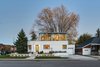 The dramatic curving glass of the second floor addition quickly recalls the original first floor's rounded edge; streamlined curves such as these are a defining characteristic of Art Moderne architecture. PPG IdeaScapes supplied the curved glass itself. Photo of Art Moderne modern home