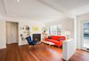 Although the main goal for the renovation of the ground floor was to create a more open floor plan, it was equally important to preserve as many details as possible. The plasterwork on the ceiling and the marble fireplace are both original features. A Florence sofa from Van Gogh Designs stands across from a feather lounge chair by Elite Living. Photo 2 of Art Moderne modern home