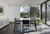 A table and accompanying chairs by EQ3 sit under a Moooi light fixture in the dining room, a room that was added to the original structure. Glass doors from NanaWall allow for the patio and dining area to become one cohesive space in the warmer months. Photo 3 of Art Moderne modern home