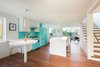 Modern home with Kitchen and White Cabinet. The owners brought their Elmira Stove Works appliances, including the Model 1958/1959 refrigerator and the matching Model 1955 stove, into their new home. Custom cabinets and IKEA chairs provide an equally bright finish. Photo 4 of Art Moderne