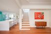 Benjamin Moore’s Cloud White paint color, which was used throughout the home, lets the African mahogany flooring stand out. Photo 5 of Art Moderne modern home