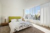 A bed from TrueModern’s Dane Collection sits between matching side tables by EQ3. When the sun isn’t shining, two Target lamps brighten the space. Photo 7 of Art Moderne modern home