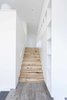 Executing subtle design details, even in transitional spaces, was one of the great successes of the collaborative architect-contractor relationship. "Our collective strength," says Dovetail principal Chad Rollins, is that “we genuinely understand each other’s craft.” In the transition from the den to the artist studio, natural myrtlewood stairs meet a wood-grain Daltile landing. Where the stair treads and risers meet the wall, a three-quarter-inch reveal is placed in lieu of conventional baseboard. These simple and clean details so often “can be costly to create and can be jeopardized when the budget is under pressure,” says Rollins. Photo 6 of Central District Residence modern home