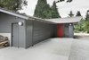 Modern home with Exterior, House Building Type, Shingles Roof Material, Wood Siding Material, and Gable RoofLine. “The stable/garage was built with two intersecting gable roof forms," Schaer says, which didn't match up with the inteiror spaces within. “In order to provide a unified, singular main space, we dropped a flat ceiling at the entrance and linked it up with the main gable visible from the street.” Photo 9 of Horse Stable Studio